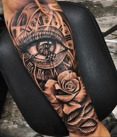 a person with a clock and rose tattoo on their arm