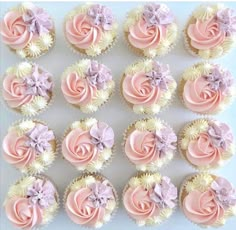 cupcakes with pink and white frosting are arranged in the shape of roses