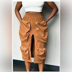 Medium Out Of Stock Cargo Skirt 3d Large Functional Zipper Pockets Slip-On Elastic Waist 3/4 Length Middle Split Non-Stretch Fabric 98% Cotton 2% Spandex Colors As Seen In Photos Model Is 5'7" & 170 Lbs And Is Wearing A Size Medium Brown Cargo Skirt With Pockets For Spring, High Waist Brown Skirt With Pockets, Stretch Knee-length Mini Skirt With Pockets, Knee-length Stretch Mini Skirt With Pockets, Trendy Knee-length Bottoms With Pockets, High Waist Cargo Skirt With Pockets For Day Out, Trendy Midi Skirt With Pockets, Brown Mini Skirt With Pockets For Spring, Spring Brown Mini Skirt With Pockets