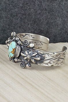 This beautifully intricate Royston turquoise and sterling silver bracelet was expertly crafted by Navajo silversmith Andrew Gordon. The inside is signed G and stamped sterling.Size: 5 1/2" (will fit up to a 6 1/2" wrist)Gap: 1"Width: 1 1/8"Free shipping on all orders! We ship with USPS and always include tracking. All orders ship within a day of payment.Returns are accepted up to 30 days after you receive your order. Just send us a message. Our shop offers cash back or store credit. The item mus Western Silver Bracelet With Patina, Bohemian Engraved Turquoise Sterling Silver Bracelet, Bohemian Turquoise Engraved Sterling Silver Bracelet, Southwestern Silver Jewelry With Patina, Silver Western Cuff Bracelet With Patina, Royston Turquoise, Turquoise Sterling Silver, Sterling Silver Bracelets, Silver Bracelet