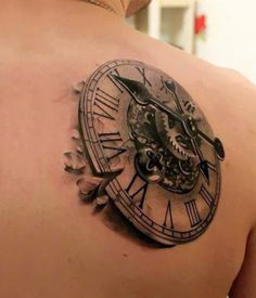 an image of a clock tattoo on the back of a man's shoulder and chest