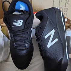 two new balance shoes sitting on top of a box