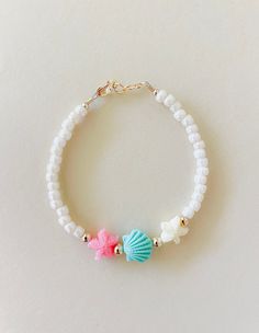 I grew up playing on the Oregon coast. This bracelet brings me back to then! Any of my coastal lovers will love this bracelet. Cream shinny beads with starfish and seashells beads! Made with hypoallergenic gold filled attachments. You will love this one! Ocean Themed Beaded Bracelets, Beach Beads Bracelets, Mermaid Beaded Bracelet, Coastal Granddaughter Bracelets, Coastal Bracelet Ideas, Gold Starfish Beaded Bracelets For Beach, Colorful Beads Starfish Bracelet For Beach, Sea Beads Bracelet, Adjustable Starfish Shell Jewelry