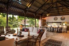 a living room filled with furniture under a roof