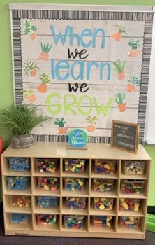 a classroom area with toys and a sign that says, when we learn we grow