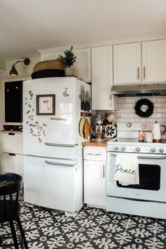 a white refrigerator freezer sitting inside of a kitchen next to a stove top oven