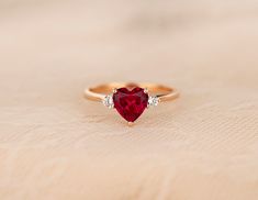 ♦ Handmade, high-quality item ♦ Material: 14K SOLID Rose Gold (can be made in Solid white/rose/yellow gold) ♦Finish: High Polishing Finish with Rhodium platting ♦ Center stone: Lab Created Ruby Heart ♦ Size/Weight: Heart 7*7mm / Approx 1.25 ct ♦ Side stones: Simulated Diamonds (CZ) ♦ Cut - Round 2.5mm ♦ Color Option: White Diamonds: D / Cognac Diamonds: C2 ♦Clarity: VVS1 ♦Cut Grade: Excellent ♦ Width of band bottom - 1.8 mm ♦ Thickness of the gold band - 1.2 mm Gold Rings With Stones, Rings Heart Shaped, Ruby Jewelry Ring, Ruby Ring Designs, Ruby Heart Ring, Heart Shape Ring, Sapphire Engagement Ring Set, Heart Promise Rings, Natural Ruby Ring