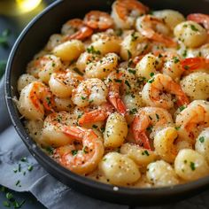 a skillet filled with shrimp and garnished with parsley