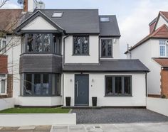 a large white house with black trim and windows