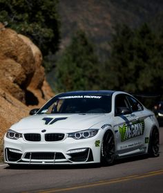 a white race car driving down the road