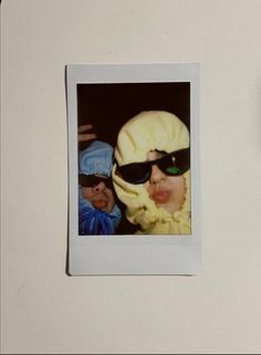 a polaroid photo of two people wearing sunglasses