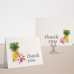 two thank you cards with pineapples and flowers on them, sitting next to each other