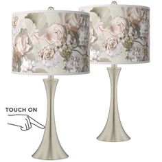 two lamps with flowers on them and one has a handwritten name underneath the lamp