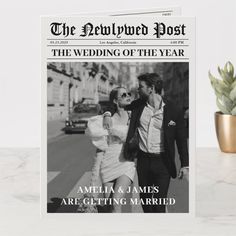 the newlywed post wedding announcement is displayed next to a potted plant and magazine cover