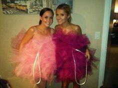 two women dressed in pink dresses posing for the camera