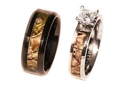 two wedding rings with camo inlays and a diamond