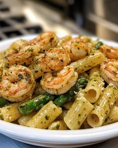 a white bowl filled with pasta and shrimp