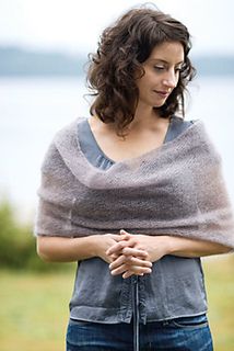 a woman standing with her hands folded over her chest