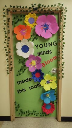 a door decorated with paper flowers and ivys that says young minds inside this room