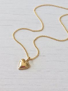 Gold Heart Necklace, Tiny Simple Heart Pendant, Delicate Gold Love Charm, Minimalist Gift for Girlfriend, Valentine's Day gift for women This dainty and delicate necklace features a tiny gold filled heart with dotted edges. The small heart pendant is suspended from a gold filled cable chain. This is a perfect layering necklace, simple and classic, you can wear this casually or dress it up. Ideal to give as a Valentine's Day Gift of an Anniversary gift for girlfriend of wife. About This Necklace Feminine Gold Heart Necklace Gift, Heart Shape Charm Necklace For Valentine's Day, Feminine Heart Necklace As A Valentine's Day Gift, Feminine Heart Necklace For Valentine's Day Gift, Valentine's Day Heart Necklace With Delicate Chain, Heart-shaped Valentine's Day Charm Necklace, Simple Heart Pendant Charm Necklace For Valentine's Day, Simple Heart Charm Necklace Gift, Simple Heart Pendant Necklace For Valentine's Day