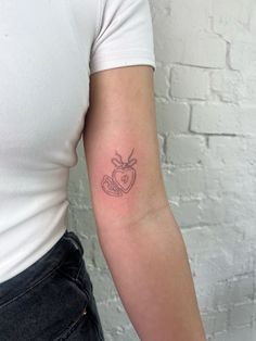 a woman's arm with a tattoo on it and a heart in the middle