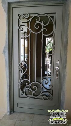 an ornate iron door is shown in this photo