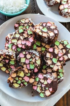 several pieces of chocolate and marshmallows on a plate with rice in the background