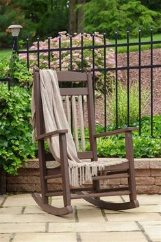 a rocking chair with a blanket on it