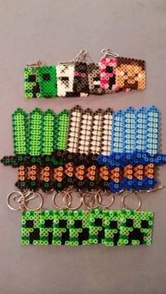 four different colored bracelets with beads on each one and two key chains attached to them