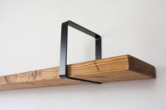 a wooden shelf with metal brackets on it