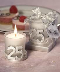 a white candle sitting on top of a table next to a box filled with cake