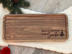 a personalized wooden tray with the words milk and cookies for santa on it