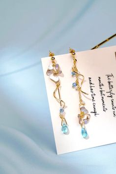 Enchanted Flower and Blue Crystal Purple Long Earrings - Froppin Blue Alloy Earrings For Gift, Whimsical Gold Metal Earrings, Light Blue Metal Earrings As A Gift, Light Blue Metal Earrings For Gift, Crystal Purple, Character Sheets, Quirky Earrings, Dried And Pressed Flowers, Professional Jewelry