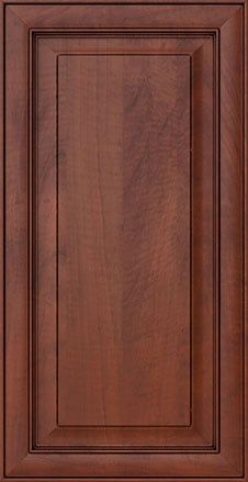 a close up view of a wooden cabinet door with the top panel painted dark brown