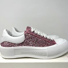 Alexander McQueen Women's Plimsol Deck Sneakers  100% Original & Authentic Guaranteed! Color: White Pink Glitter   Size: 10 US / 40 EU  Style Code: 676687 W4RN3 5686 Brand New In Box With Original Spare Laces  *Missing Box Label* Glitter low-top enhanced with leather heel patches. Canvas upper leather Tab Almond toe Lace-up vamp Rubber sole Made in Italy All our items are 100% Authentic Guaranteed  Item pictured is item being sold. Please review all pictures carefully before purchasing. Please feel free to message me with any questions!International Buyers: Please send us a message to inquire about shipping options to your country. Pink Sneakers With Glitter Print For Spring, Pink Glitter Print Lace-up Sneakers, Casual Low-top Sparkling Sneakers, Pink Low-top Sneakers With Glitter Print, Trendy Sparkling Low-top Sneakers, Trendy Pink Sneakers With Glitter Print, Glitter Print Lace-up Sneakers For Streetwear, Pink Sparkling Sneakers With Round Toe, Pink Glitter Sneakers For Streetwear