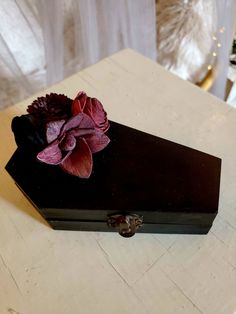 a black box with a purple flower on it