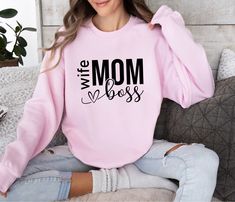 Wife Mom Boss Sweatshirt - Empowering Women's Clothing for Super Moms! Upgrade your wardrobe with this Wife Mom Boss sweatshirt! Made with a soft and cozy fabric blend, this sweatshirt is perfect for those days when you're juggling the many roles of a wife, mom, and boss. With a stylish design featuring bold typography, this sweatshirt will make a statement wherever you go. Whether you're running errands, attending meetings, or simply relaxing at home, this Wife Mom Boss sweatshirt is a must-hav Super Mama, Funny Grandma, Sweatshirt Trendy, Gift For Mothers Day, Trendy Mom