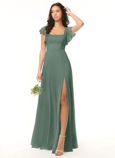 a woman in a long green dress is posing for the camera with her hand on her head