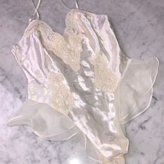 New Never Used Mint Condition Size S O White Spring Bodysuit For Bedtime, Fitted White Bodysuit For Sleep, White Elegant Camisole Bodysuit, Elegant White Camisole Bodysuit, Fitted White Victoria's Secret Sleepwear, Fitted Sheer Victoria's Secret Sleepwear, Fitted Sheer Sleepwear By Victoria's Secret, Fitted Cream Sleeveless Sleepwear, Fitted Cream Sleepwear For Bedtime