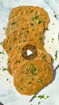 three flatbreads on a white plate with parsley sprinkled around them