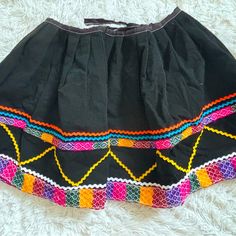 Mexican Embroidered Circle Skirt, Pull On, Tie Back, Never Worn, Fits A Small From Mexico Colorful Embroidered Trim No Zip Or Button Tie Back No Size Noted Traditional Cotton Skirt For Festival, Traditional Multicolor Cotton Skirt, Traditional Multicolor Embroidered Skirt, Folk Style Multicolor Embroidered Skirt, Casual Embroidered Multicolor Skirt, Embroidered Cotton Skirt, Summer Festival Skirt With Multicolor Embroidery, Fitted Cotton Skirt With Embroidered Hem, Casual Multicolor Embroidered Skirt