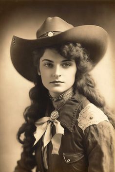 an old photo of a woman wearing a cowboy hat