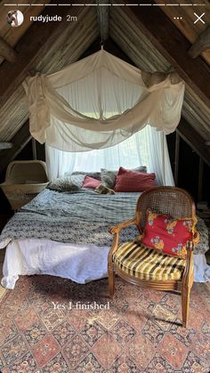 a bed sitting in the middle of a bedroom next to a chair