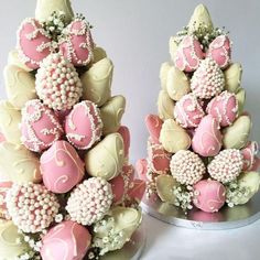 two cakes decorated with pink and white chocolates