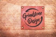 a red square with the words grundtone design on it sitting on top of a wooden table