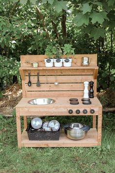 an outdoor cooking area with pots and pans