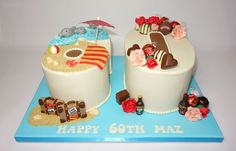 two cakes decorated with beach scenes and decorations