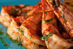 cooked shrimp on a blue plate garnished with parsley