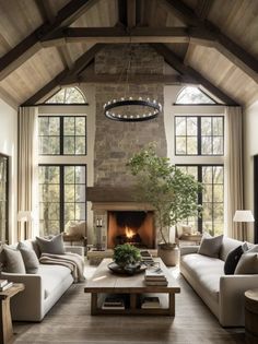 a living room filled with lots of furniture and a fire place in the middle of it