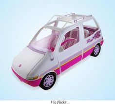 the toy car is white and pink with flowers on it